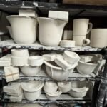 A bunch of plaster molds sitting on shelving