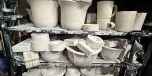 A bunch of plaster molds sitting on shelving